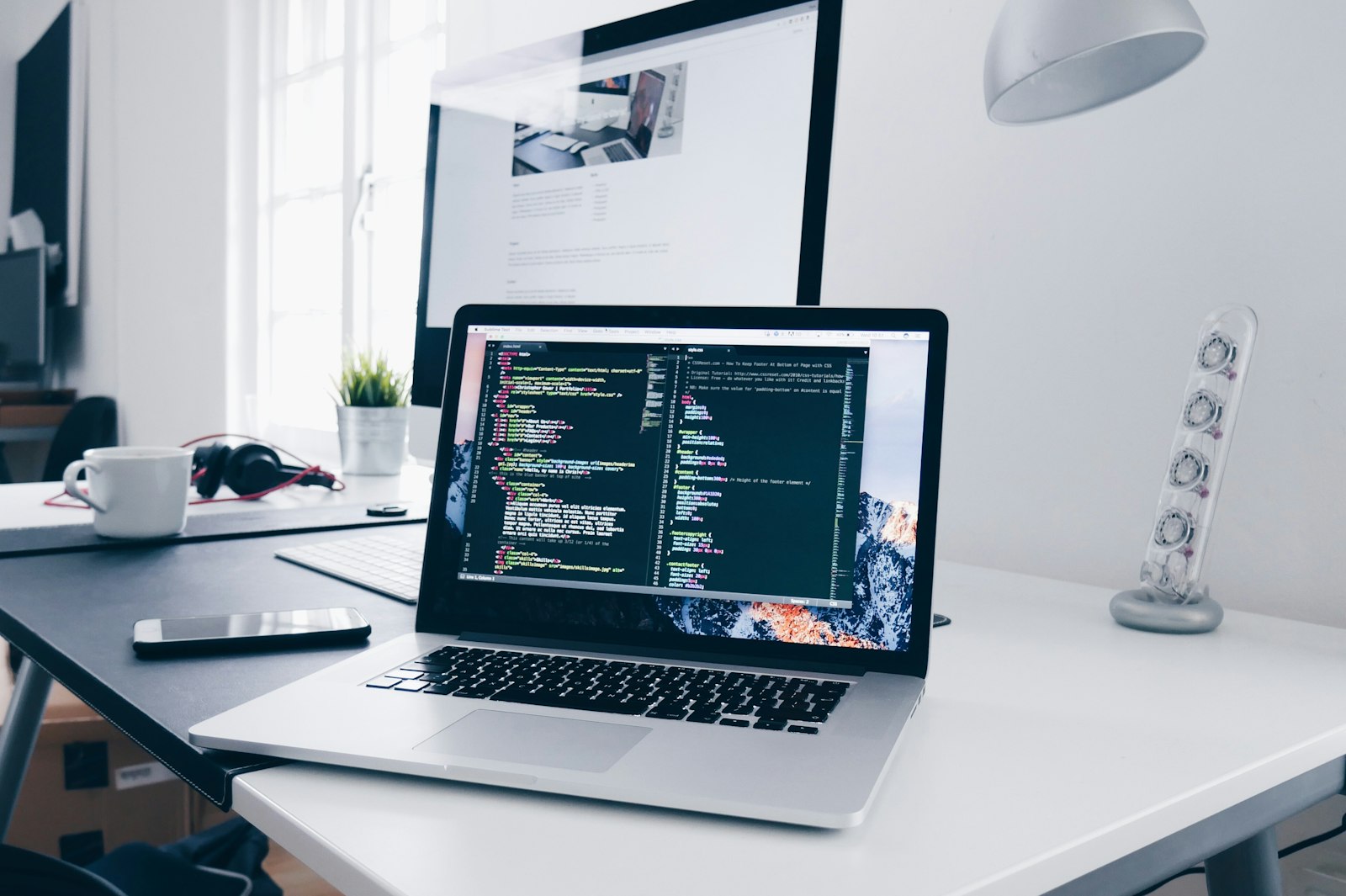 Workstation with code on screen at the RabStack studio in Montevideo